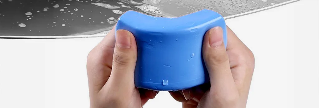 Kneading clay bar on white background