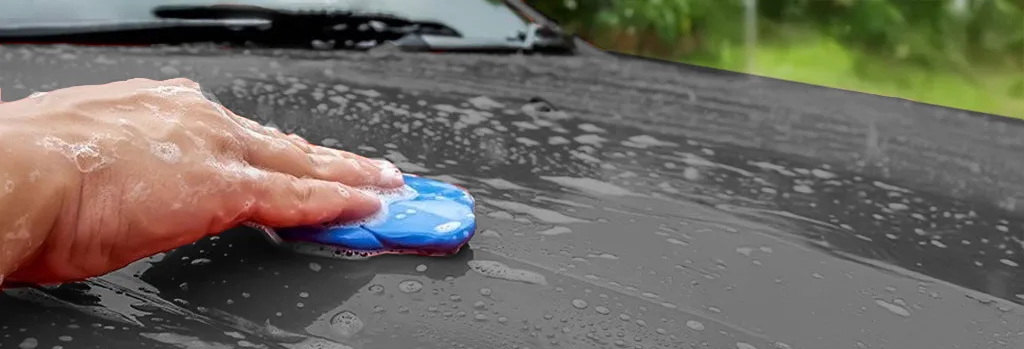 Clay bar gliding on car paint on white background