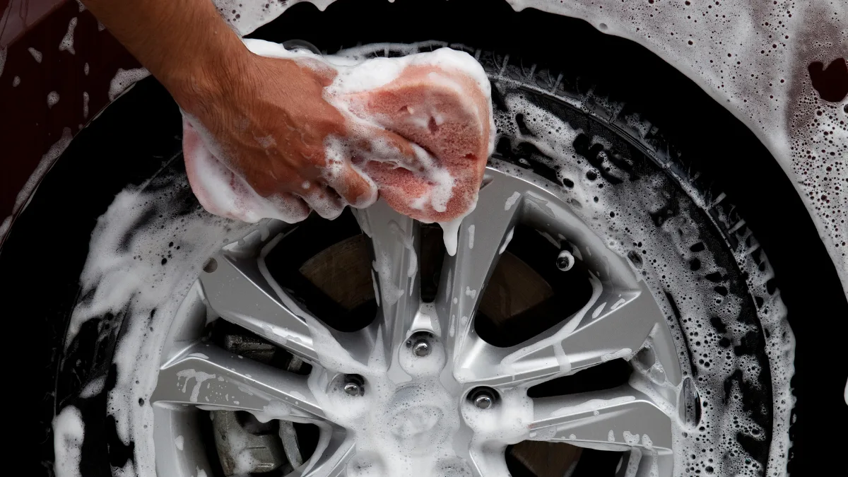 Cleaning car tires on white background