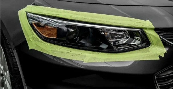 Automotive masking tape protecting trim on white background