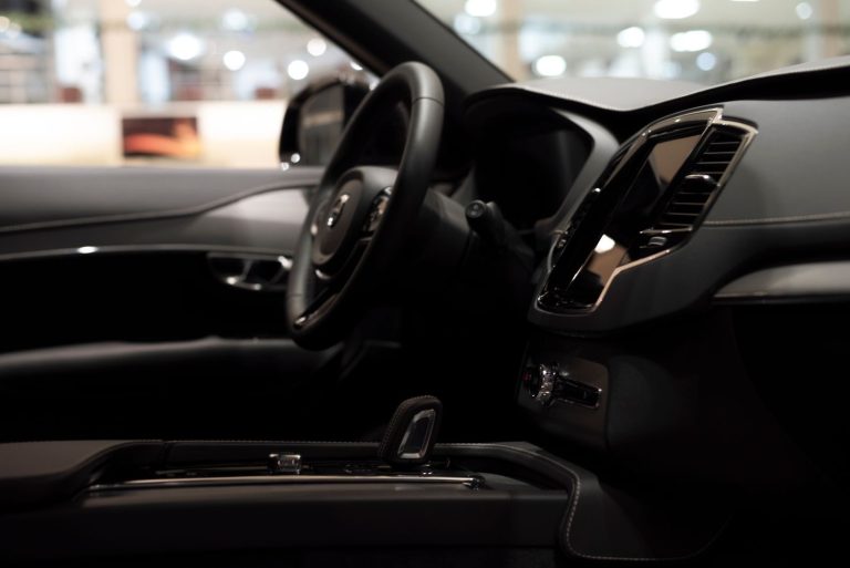 Spotless car interior after a full interior detail, dashboard, touchscreen and steering wheel